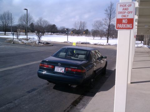 1998 Toyota Camry - Rear view of a 1998 Toyota Camry sedan parked in a lot with snow on the ground.