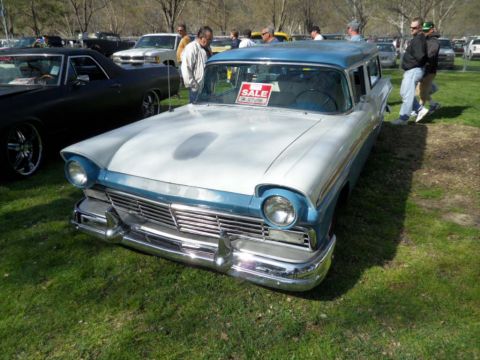 1973 Ford Ranchero - A two-tone blue and white station wagon, likely a 1957 model, is parked on a grassy field with a FOR SALE sign displayed in the window.