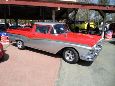 1973 Ford Ranchero - A two-tone red and silver 1957 Ford Ranchero is parked at an outdoor event.