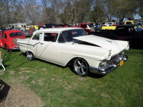 1973 Ford Ranchero - A classic white Ford Fairlane 500 is displayed at an outdoor car show with other vehicles in the background.