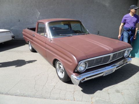 1973 Ford Ranchero - A 1963 Ford Falcon Ranchero pickup truck is seen from the front-three-quarter angle, with a partial view of another vehicle to the left.