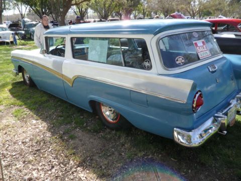 1973 Ford Ranchero - A two-tone blue and white 1956 Ford Fairlane wagon is parked on grass at an outdoor event.