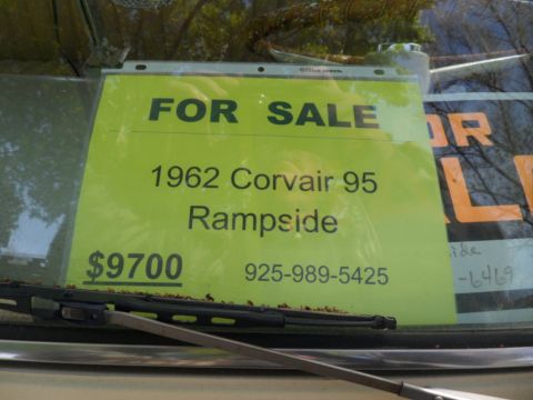 1973 Ford Ranchero - A bright yellow sign in a car window advertises a 1962 Corvair 95 Rampside for $9700.