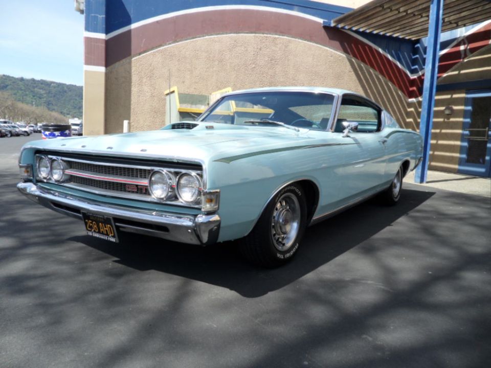 Light blue 1968 Ford Torino GT fastback parked in front of a building