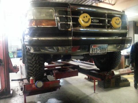 1995 Ford Bronco - This 1995 Ford Bronco is on a lift, custom smiley face fog lights and a personalized license plate.
