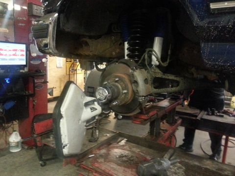1995 Ford Bronco - Front suspension and brake assembly of a 1995 Ford Bronco undergoing service.