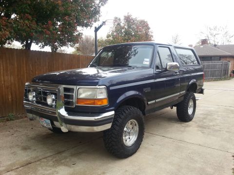 1995 Ford Bronco - This 1995 Ford Bronco is shown from a three-quarter front view, parked in a suburban driveway.