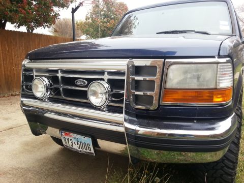 1995 Ford Bronco - The grille and headlights of a Ford F-150 truck are visible in this front-facing shot.