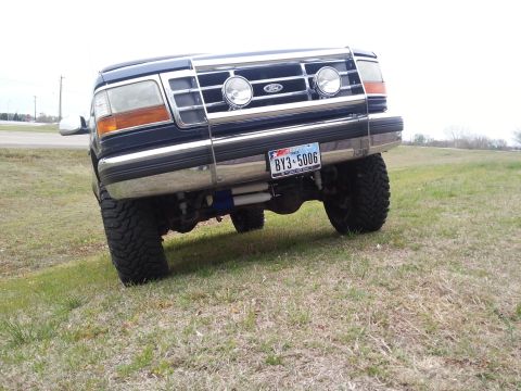 1995 Ford Bronco - This Ford Bronco is equipped with a chrome grille guard and large off-road tires.