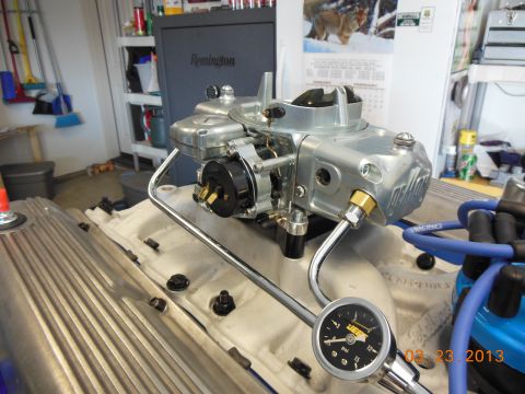 1979 Ford F-150 - A close-up view of a newly installed Holley carburetor on an engine, with a fuel pressure gauge visible.