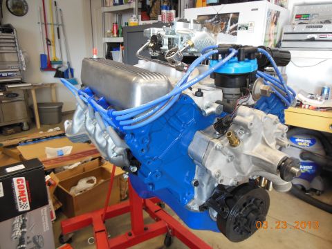 1979 Ford F-150 - Engine assembly with blue block and silver valve covers, mounted on an engine stand in a garage setting.
