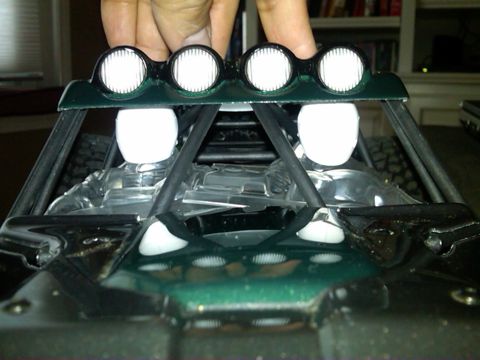 1986 Ford Bronco - A toy off-road vehicle's interior is shown, a light bar with four circular lights and two white figures.