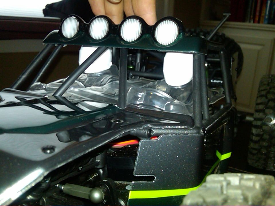 Close-up of a remote control buggy interior with roll cage and roof lights