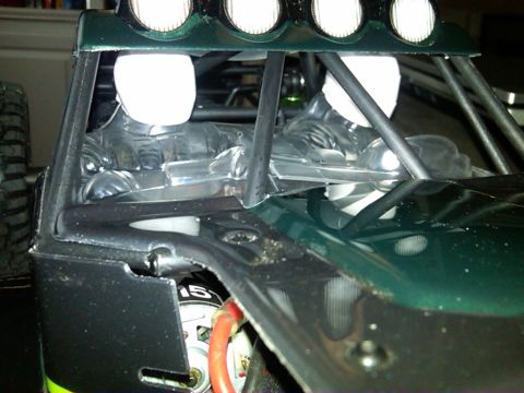1986 Ford Bronco - Close-up view of a model car's interior, showing figures and roll cage details.