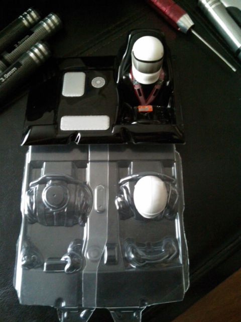 1986 Ford Bronco - Packaging for toy car interior parts and a driver figure, with tools visible.