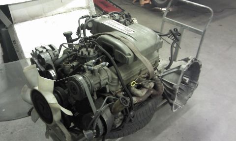 1967 Ford F-100 - Engine and transmission assembly, likely from a Ford truck, with "5.0 EFI" visible on the valve cover.