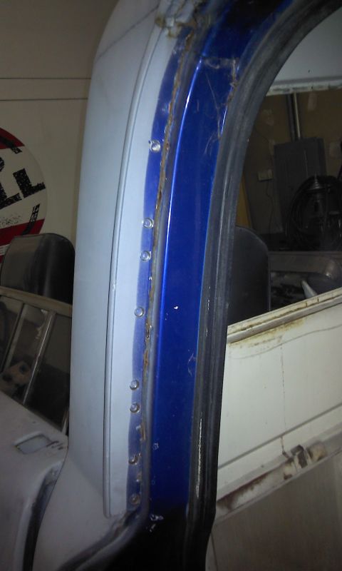 1967 Ford F-100 - Detail shot of a truck's door jamb, showing the blue paint and metal construction.