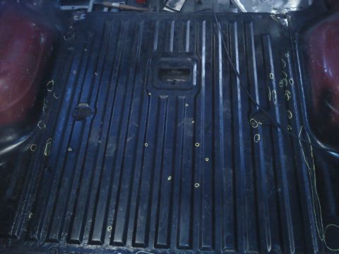 1978 Ford Bronco - The interior cargo area shows a ribbed floor with various markings, suggesting preparation for work or modification.