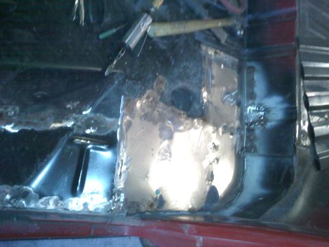 1978 Ford Bronco - Floor pan rust repair in progress, showing damaged metal and tools.