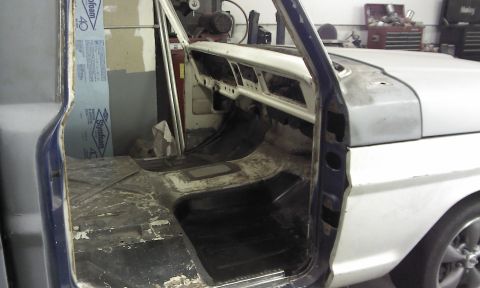 1967 Ford F-100 - The interior of a 1967 Ford F-100 shows a stripped floor and dashboard, indicating restoration work.