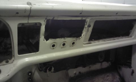 1967 Ford F-100 - The dashboard of a vehicle shows empty spaces where instruments and controls would be installed.