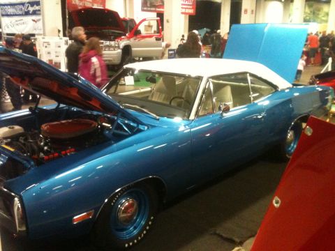2004 Ford Crown Victoria - Blue 1970 Dodge Super Bee on display with hood open, white roof visible.