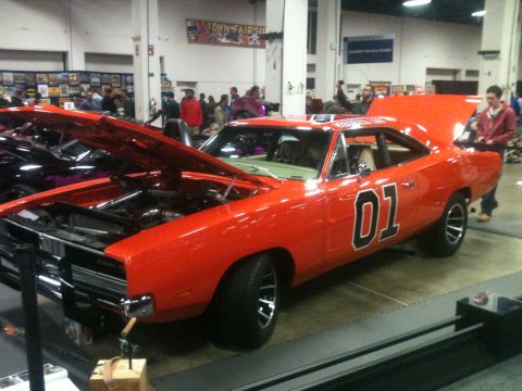 2004 Ford Crown Victoria - Iconic orange 1969 Dodge Charger, famously known as the "General Lee", displayed with both hoods open.