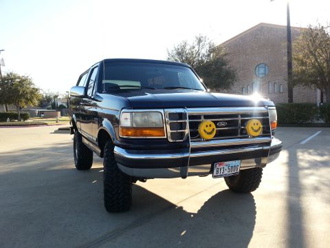 1995 Ford Bronco - This 1995 Ford Bronco is parked outside a building on a sunny day.