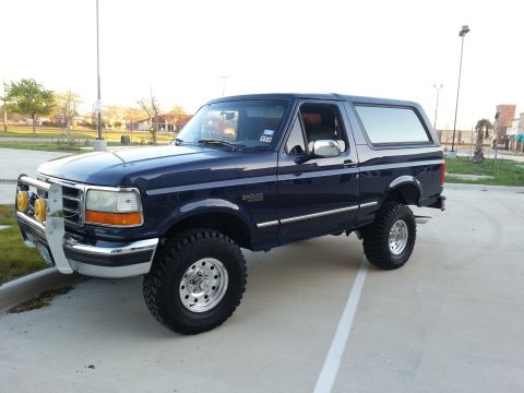1995 Ford Bronco - This lifted 1995 Ford Bronco features a dark blue exterior and aggressive off-road tires.