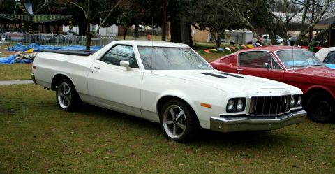 1980 Ford Mustang - White 1977 Ford Ranchero parked outdoors next to a red car.