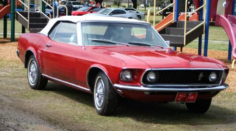 1980 Ford Mustang - This red convertible is a classic car, likely from 1969, not a 1980 model.