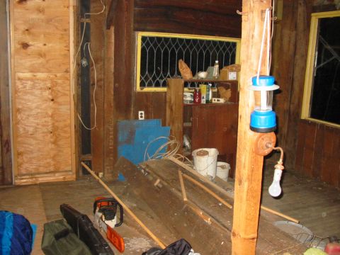 1992 Ford Bronco - Tools and supplies are scattered around the interior of a rustic wooden room.