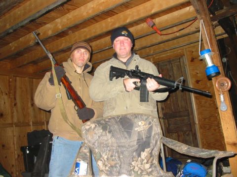 1992 Ford Bronco - Two men pose with firearms in a rustic indoor setting.