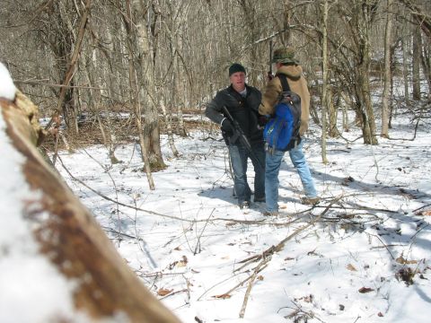 1992 Ford Bronco - Two individuals are in a wooded area during winter, with snow on the ground.