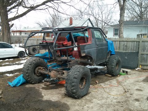 1986 Ford Bronco - This heavily modified vehicle features a custom roll cage and oversized tires, suggesting it is built for off-road use.