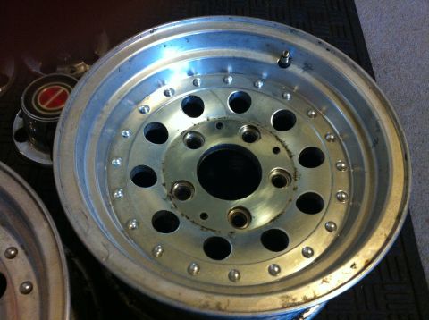 1992 Ford F-150 - Close-up of an aftermarket aluminum alloy wheel, likely for a truck or SUV, with a visible center cap.