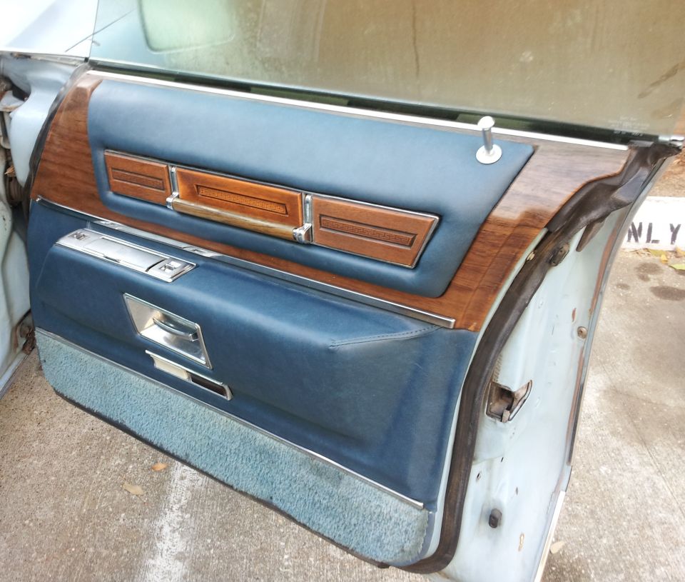 blue vinyl and wood grain door panel with chrome accents