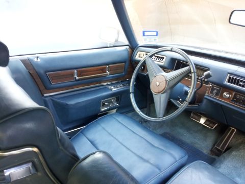 2008 Subaru Legacy - The interior features blue vinyl seats, wood grain accents on the door panels, and a distinctive star-shaped steering wheel.