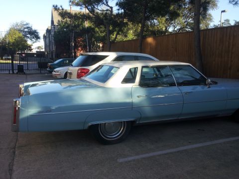 2008 Subaru Legacy - A light blue sedan with a white vinyl roof is parked next to other vehicles.