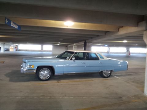 2008 Subaru Legacy - Side view of a light blue 1974 Cadillac Sedan de Ville in a parking garage.