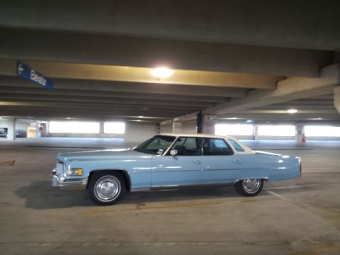 2008 Subaru Legacy - A classic light blue sedan with a white roof is parked in a concrete parking garage.