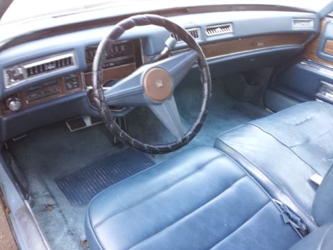 2008 Subaru Legacy - The interior of a car shows blue seats and dashboard details.