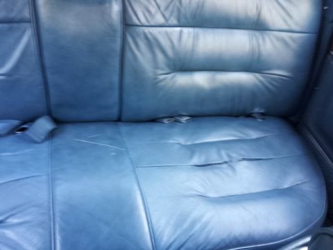 2008 Subaru Legacy - Interior view of blue leather rear car seats, showing seat belts and stitching detail.