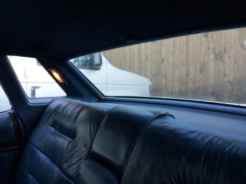 2008 Subaru Legacy - View of the rear interior of a vehicle, with a white van parked outside.