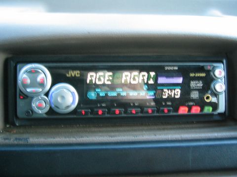 1996 Ford Bronco - A JVC car stereo is visible in the dashboard, displaying song information and the time.