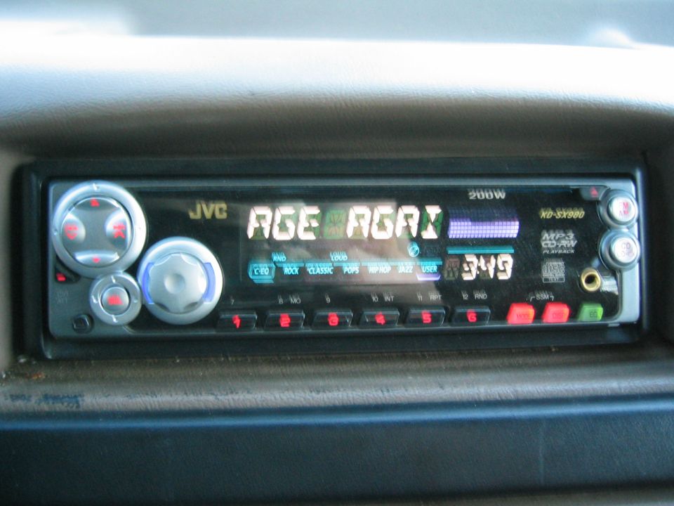JVC car stereo with digital display showing 'AGE AGRI' and time '3:49'