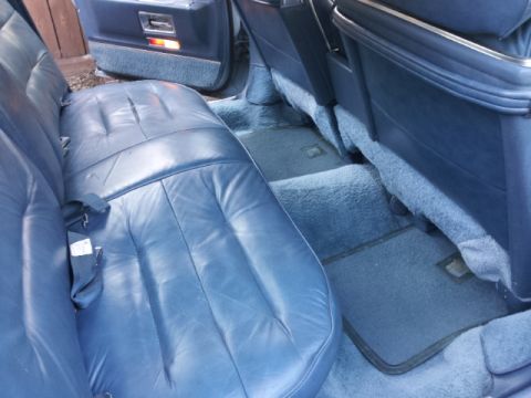 2008 Subaru Legacy - The interior of a car shows blue leather rear seats and matching blue carpet on the floor.