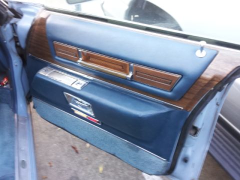 2008 Subaru Legacy - Close-up of a car's interior door panel, blue upholstery and wood accents.