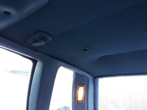 2008 Subaru Legacy - The interior of a vehicle shows the headliner and window frames, with a visible dome light.