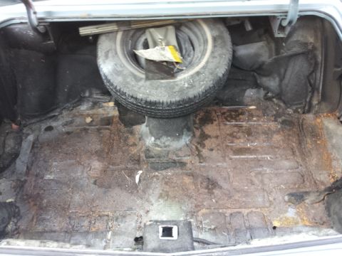 2008 Subaru Legacy - The trunk interior shows a spare tire and significant rust on the floor panel.